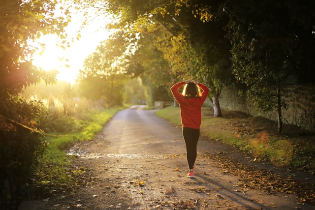 People engaging in outdoor activities like yoga, jogging, and hiking amidst lush green landscapes for a healthy lifestyle.