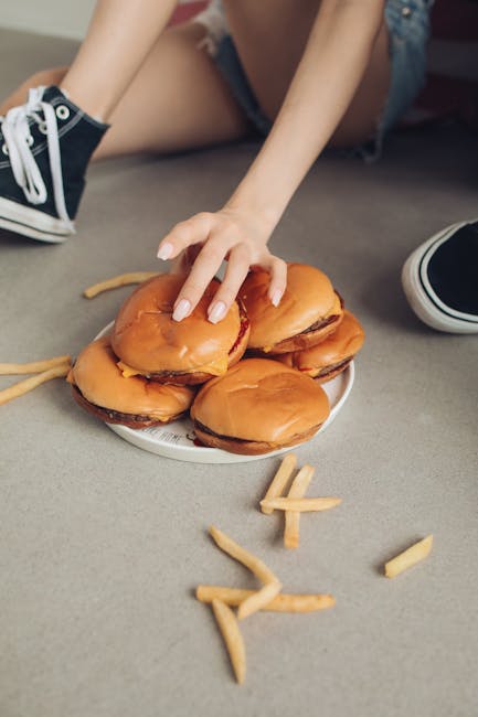 A plate of unhealthy foods with a red X marked through it, warning sign, or crossed out design, conveying overindulgence and nutrition mistakes.