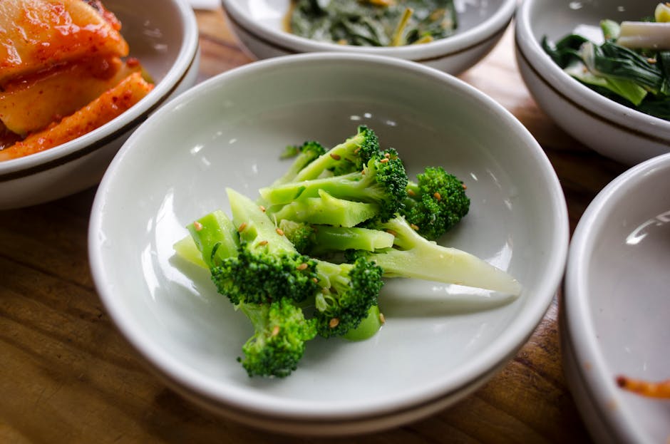 A vibrant array of fresh fruits and vegetables on a wooden table, showcasing essential nutrients like carrots, broccoli, and avocados in a healthy and colorful display.