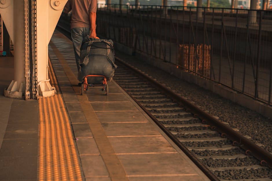 A traveler amidst bustling airport or train station chaos, surrounded by luggage and people, embodying excitement and adventure in travel.