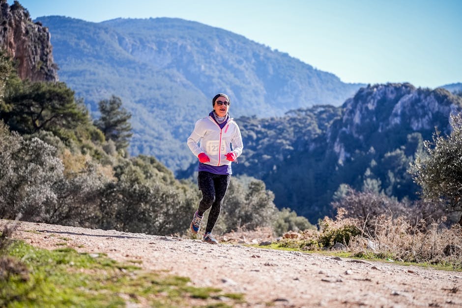 A person trekking or hiking in a scenic mountainous landscape, exuding freedom, excitement, and an adventurous outdoor lifestyle.