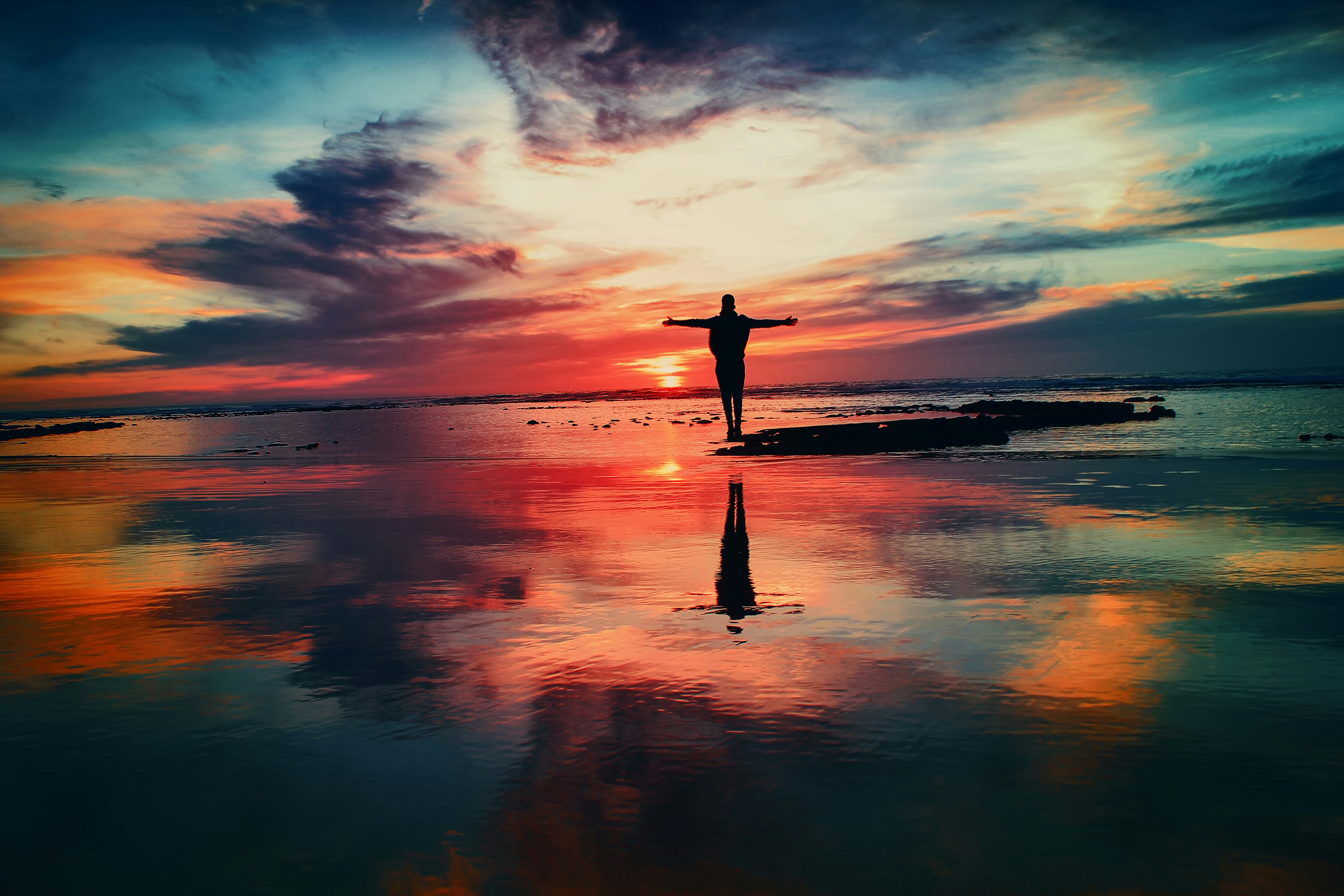 Woman in her 30s practices yoga or meditation in a serene natural outdoors setting, radiating calm and inner peace.